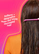 Person with long hair using a pink comb against a pink background with text about hair care.